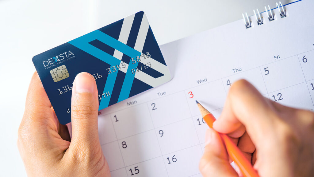 person holding credit card next to a calendar for a blog about How to Stop Unnecessary Recurring Charges on a Credit Card