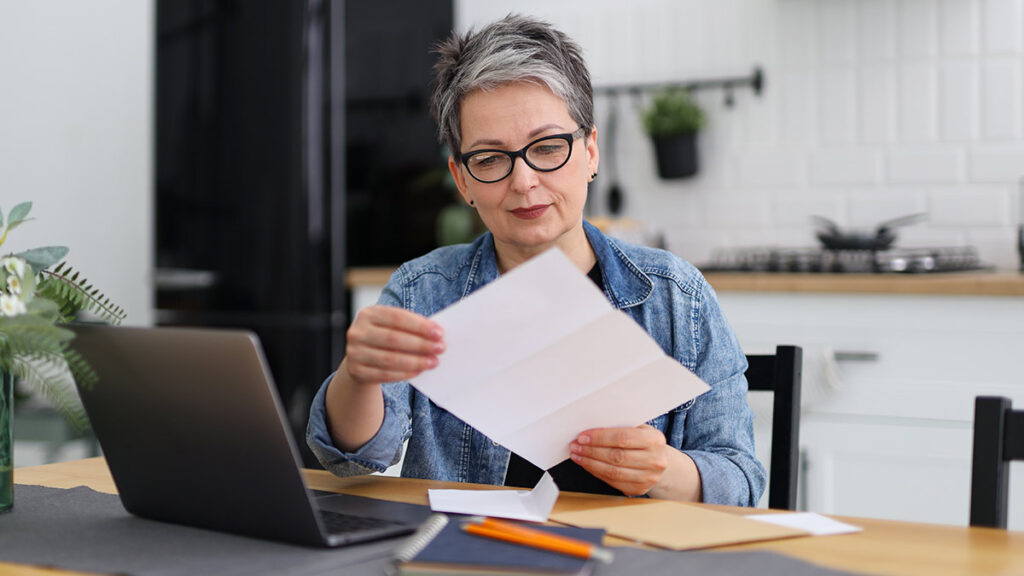 woman looking at paperwork for a blog about red flags on bank statements