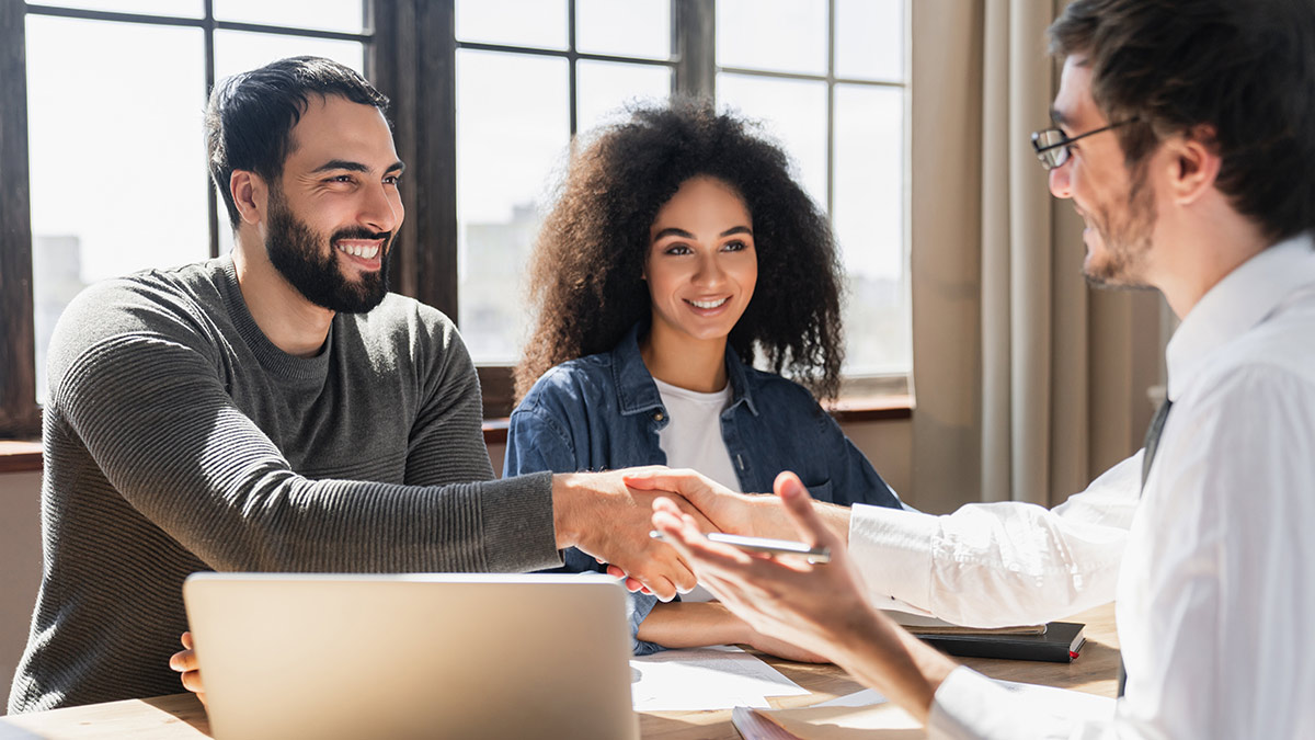 couple meeting with a loan officer for a blog about duties of a loan officer