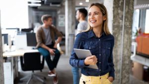 woman in corporate office for a blog about how to manage money as a new professional