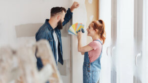 couple looking at paint swatches in new home for a blog about home equity loan for remodel expenses
