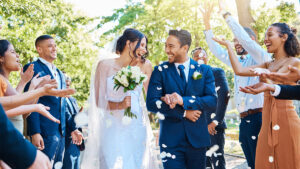 young couple walking down the aisle after getting married for a blog about planning a wedding on a budget